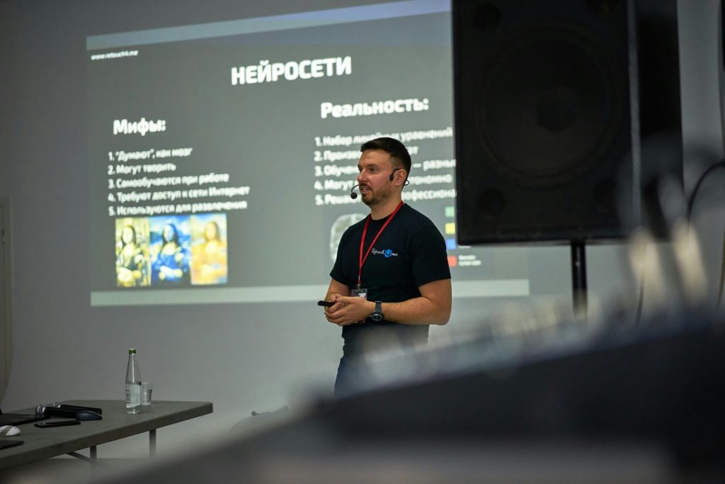A man standing in front of a projector screen